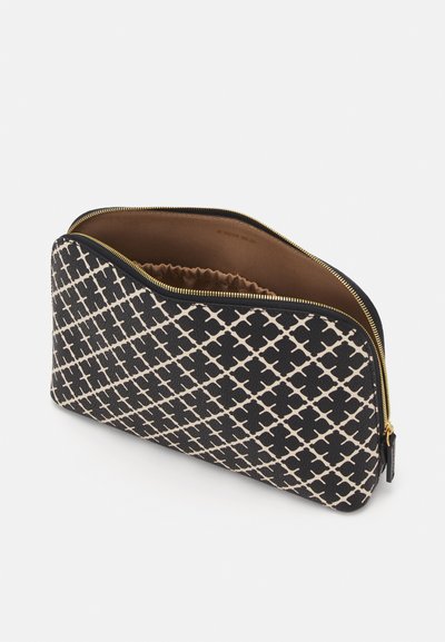 Black and cream patterned zippered pouch with a quilted interior. Features a curved top, gold zipper, and a textured surface.