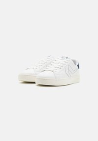 Sneakers bianchi in pelle con una texture liscia, caratterizzati da accenti blu e un design a strisce sui lati e sulla linguetta. Silhouette bassa.
