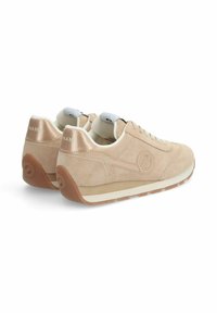 Beige suede sneakers with rubber sole, white laces, and a round logo accent on the side. Cushioned collar and tongue for comfort.