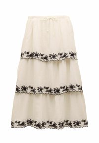 Biela viacvrstvová sukňa z ľanu s čiernou kvetinovou výšivkou pozdĺž vlnitých okrajov. V páse so šnúrkou na nastavenie veľkosti.
