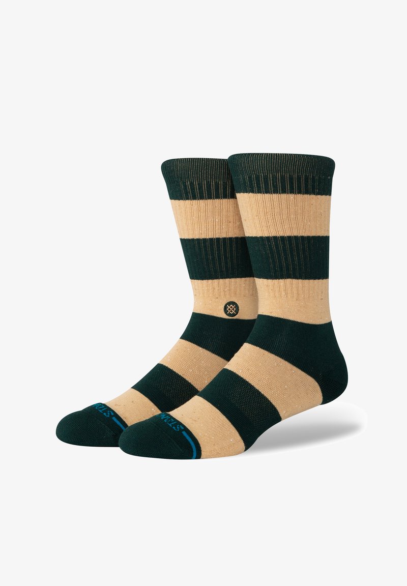 Gestreepte sokken met afwisselend donkergroene en beige kleuren, ribbelstructuur, versterkte teen en een klein logo aan de zijkant.