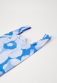Blue floral-patterned fabric with white accents; features a sleeveless design and rounded neckline. Smooth texture, lightweight material.