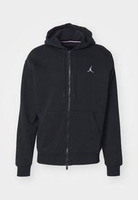 Black zip-up hoodie with front pockets, drawstring hood, and small white Jumpman logo on the left chest.