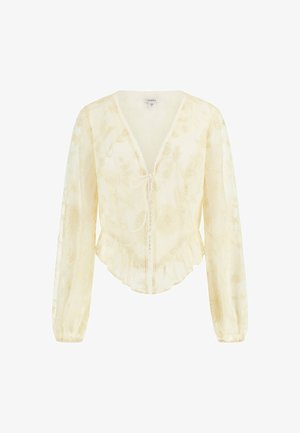 Genomskinlig gul blus med blomsterbroderi, V-ringning med snörning, långa ärmar och volang i nederkant.