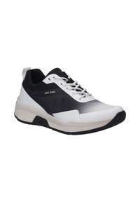 White and black sneaker with a textured upper, lace closure, padded collar, and a cushioned, flexible sole. Features a subtle logo detail.