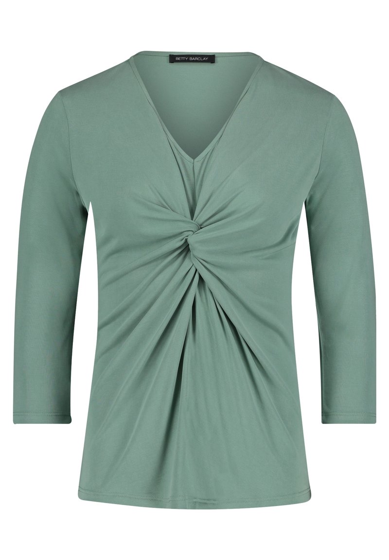 Světle zelený top s dlouhými rukávy a výstřihem do V, s detailním twistem v přední části, vyrobený z hladkého, elastického materiálu. Čistý, jednoduchý design.