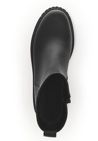 Bottines noires en cuir lisse, avec un bout rond, des panneaux latéraux élastiques et une languette au talon. Semelle en caoutchouc texturé.