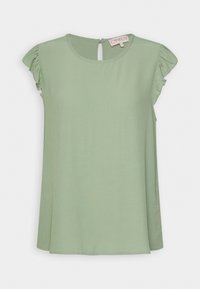 Jasnozielona bluzka z krótkim rękawem, z falbanami przy rękawach, okrągłym dekoltem i szczegółem w postaci otworu na plecach. Gładki, lekki materiał.