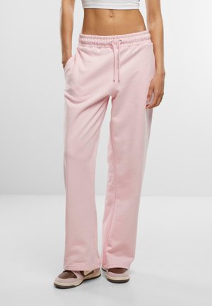 Lyserøde sweatpants laget av myk stoff; elastisk midjebånd med snøring; har sidelommer og en avslappet passform.