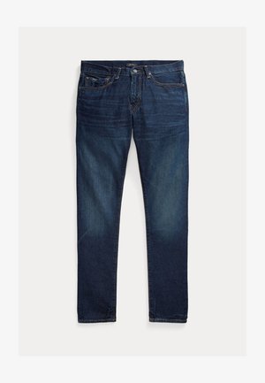 Ciemnoniebieskie dżinsy o dopasowanym kroju z pięcioma kieszeniami, zapięciem na guzik oraz subtelnym wyblaknięciem na udach i kolanach.