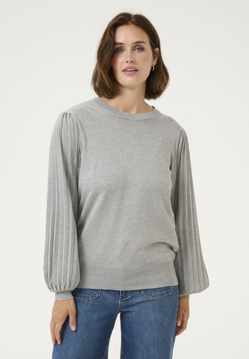 Light gray sweater with ribbed, puffed sleeves and a crew neckline. Soft texture and loose fit. Paired with denim jeans.