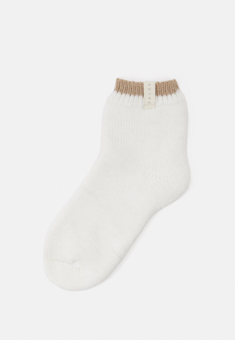 Chaussette de cheville en blanc et brun clair, dotée d'un bord côtelé. Fabriquée dans un matériau doux avec un design de pointe sans couture et une étiquette de marque.