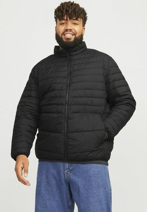 Black padded jacket with a high collar and front zipper. Features quilted pattern and relaxed fit. Ideal for warmth and comfort.