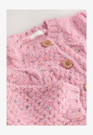 Textured pink knit cardigan featuring multicolored specks, two wooden buttons, and a cable knit pattern. Label reads "NEXT."