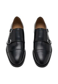 Black leather double monk strap shoes featuring silver buckles, a smooth finish, rounded toe, and detailed stitching along the sides.