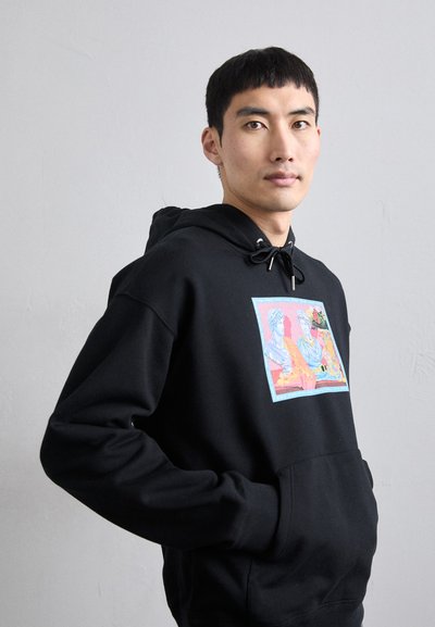 Black hoodie featuring a graphic print of two figures in blue and orange hues, with a bordered light blue accent and adjustable drawstrings.