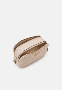 Borsa in ecopelle beige trapuntata con zip e hardware dorati. Presenta due scomparti, design compatto e texture liscia.