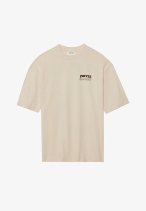 Béžové bavlnené tričko s krátkymi rukávmi, s hnedou grafikou "COFFEE HARMONY" na ľavej oblasti hrude. Štandardný dizajn s okrúhlym výstrihom.
