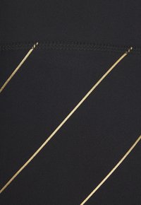 Black fabric featuring diagonal gold stripes. The texture appears smooth and the stripes are metallic and slightly raised.