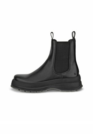 Schwarze Lederstiefelette mit elastischen Seiteneinsätzen, Ziehlaschen oben und dicker Gummisohle mit profiliertem Laufsohle.