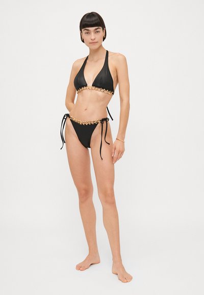 Black bikini set featuring a triangle top with metallic chain accents and a matching bottom with adjustable tie sides. Smooth texture.