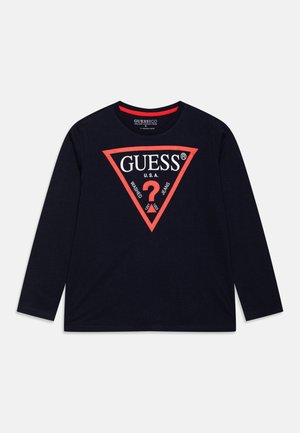 Mornarica dolg rokav majica iz bombaža z rdečim trikotnim logotipom. Na sredini ima napis "GUESS U.S.A." in grafiko vprašaja.