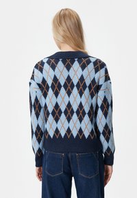 Sweter robiony na drutach z diamentowym wzorem w jasnoniebieskim, granatowym i pomarańczowym kolorze, z ściągaczem przy kołnierzu i mankietach, o luźnym kroju.
