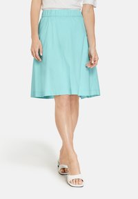 Falda de longitud a la rodilla en color azul claro, con cintura elástica, hecha de una tela suave, con un diseño acampanado y detalles de costura simples.