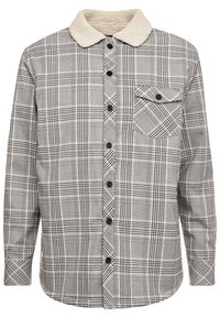 Rutig skjorta i grått med svarta och vita mönster, med en beige fleecekrage, knäppning och en bröstficka med lock.