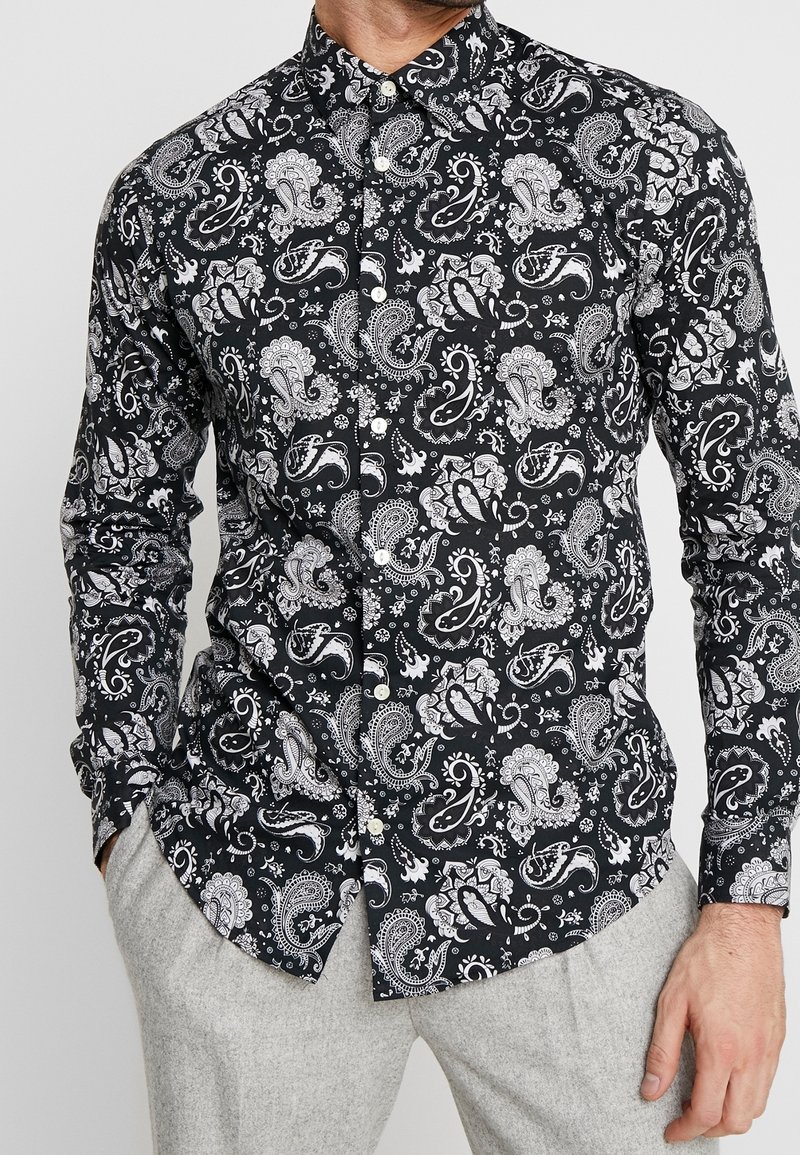 Camicia nera con motivo paisley bianco, colletto button-down e maniche lunghe, realizzata in un tessuto morbido con una vestibilità slim.