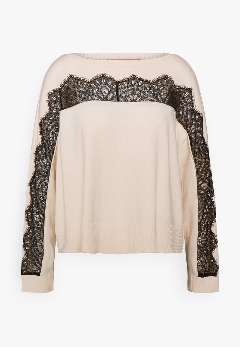 Pull crème à manches longues avec bordure en dentelle noire le long de la poitrine supérieure, des épaules et des manches, poignets et ourlet côtelés.