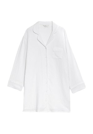 Chemise de pyjama en coton blanc à manches longues, avec un col en V et une poche poitrine. Présente un tissu texturé et une fermeture à boutons.