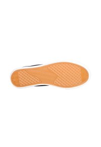 Sole di sneaker nera con un motivo in gomma testurizzata, dotata di una suola color gomma e un bordo bianco. Progettata per offrire trazione e durata.