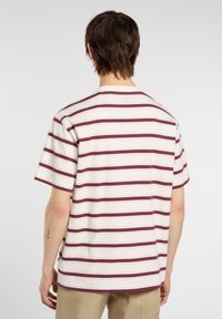 A person with short hair wears a striped short-sleeve shirt, facing away, showcasing a light base with maroon and pink horizontal stripes.