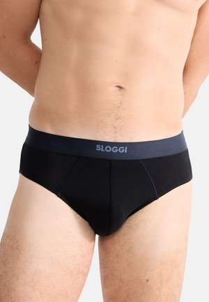 Schwarze Sloggi Panty mit einem dunklen Bund mit Logo, aus glattem Material und einer taillierten Passform, die sich dem Körper anpasst.