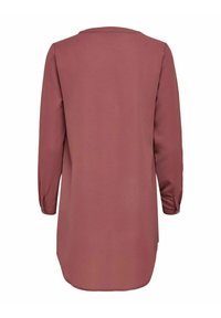 Langärmlige, kastanienfarbene Tunika aus strukturiertem Stoff. Verfügt über einen runden Ausschnitt und knöpfbare Manschetten. Gerader Schnitt mit abgerundetem Saum hinten.