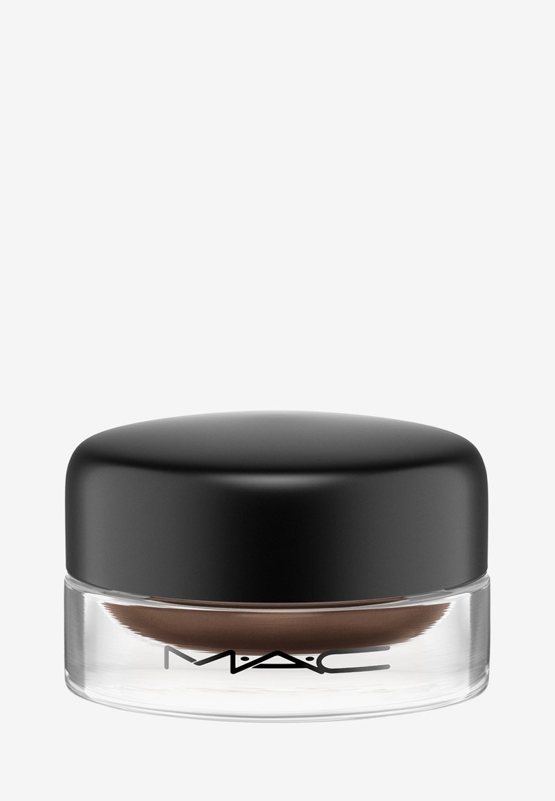 Prodotto crema marrone in un barattolo di vetro trasparente con un coperchio liscio e nero; etichettato con "MAC" in lettere nere sul fronte.