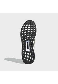 Semelle de chaussure en caoutchouc noir avec motif de bande de roulement circulaire, amorti blanc visible à travers les espaces, et logo "Continental" près du centre supérieur.