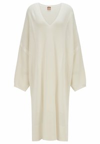 Abito in maglia oversize a V, di colore bianco sporco, con maniche corte e un motivo testurizzato, orlo dritto e spacchi laterali.