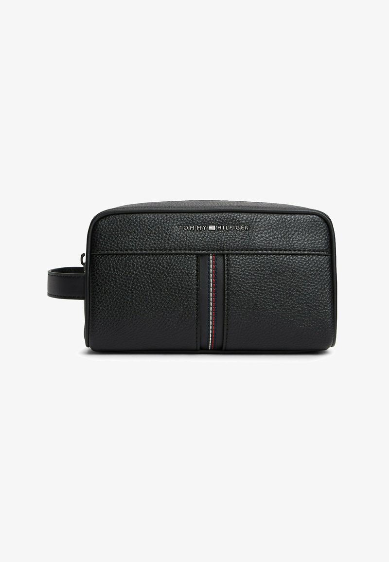 Black textured leather toiletry bag with side handle, vertical red, white, and blue stripe, and Tommy Hilfiger logo on front.