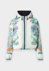 Kapuutsiga lukuga jakk, millel on värvilised lille- ja tiigrimustrid, hele türkiissinine ja kreemikas taust, nöörid ning "Just Cavalli" bränditeksti aktsendid.