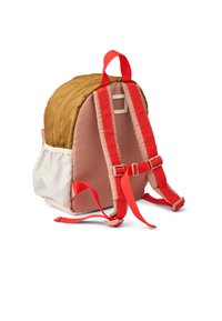 Backpack with a golden-brown top, pink sides, white base, and red straps. Features a buckle and soft, padded texture. Compact design.