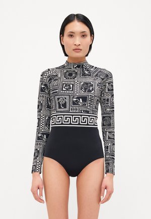 Long-sleeve swimsuit with a black and white patterned design featuring geometric and floral motifs. High neck and fitted silhouette.