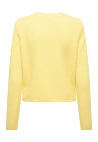 Gul strikkegenser med lange ermer, rund hals og cropped passform. Laget av et teksturert stoff med et mykt utseende.