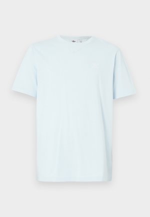 Light blue cotton t-shirt with short sleeves, round neckline, and a small white logo on the upper left chest. Soft texture, casual fit.