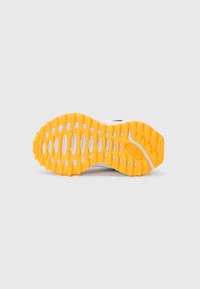 Sneaker sole with a textured grip in bright orange rubber and white components. Features elongated grooves and small raised accents.
