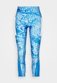 Siniset legginsit, joissa on leopardikuvio, korkea vyötärö, kontrastina valkoiset sivupaneelit ja sileä, joustava rakenne.