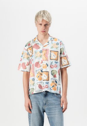 Short-sleeve button-up shirt featuring a colorful fruit print on a light background, with a relaxed fit and soft fabric texture.