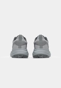Gray athletic shoes with a mesh upper, padded collar, and a textured rubber sole. Features a pull tab at the heel and a smooth design.