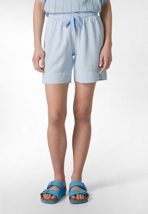 Light blue, knee-length shorts made of soft fabric with an elastic waistband and drawstring. Pair with blue sandals featuring two straps.